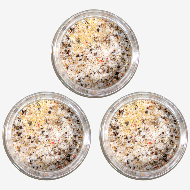 A top view of three open jars of Toomey's Seasoning.